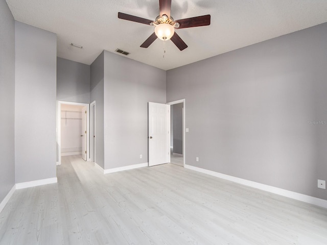 spare room featuring ceiling fan and light hardwood / wood-style flooring