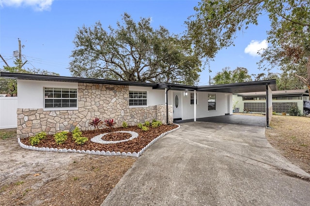 ranch-style house featuring a carport