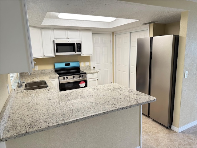 kitchen with white cabinetry, appliances with stainless steel finishes, and kitchen peninsula