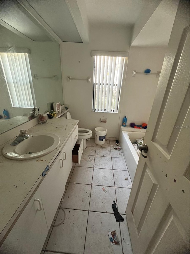 bathroom featuring vanity, tile patterned floors, a tub, and toilet