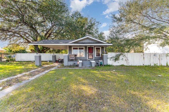 view of front of property with a carport, covered porch, and a front lawn