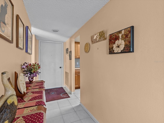 134 Mariner Dr Unit 134, Tarpon Springs, FL 34689 - hall featuring light tile patterned floors and a textured ceiling