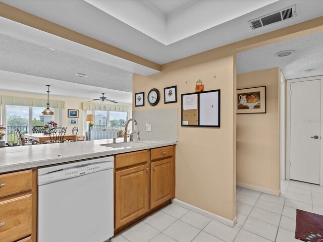 134 Mariner Dr Unit 134, Tarpon Springs, FL 34689 - kitchen with light tile patterned flooring, sink, a textured ceiling, dishwasher, and pendant lighting