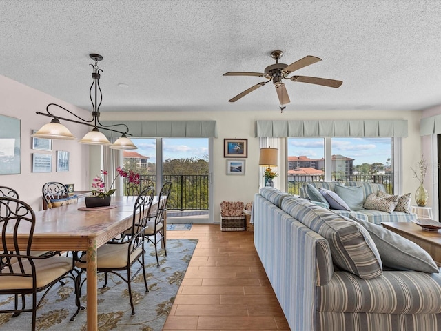 134 Mariner Dr Unit 134, Tarpon Springs, FL 34689 - interior space featuring ceiling fan, hardwood / wood-style flooring, a textured ceiling, and a healthy amount of sunlight