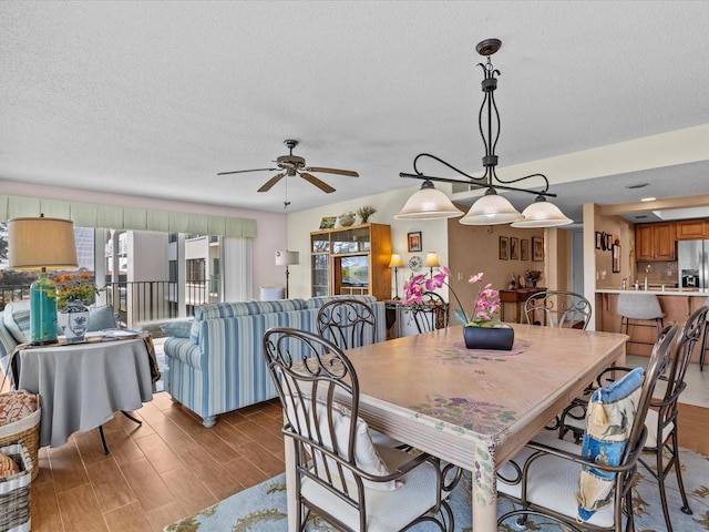 134 Mariner Dr Unit 134, Tarpon Springs, FL 34689 - dining area with ceiling fan, a textured ceiling, and dark hardwood / wood-style flooring