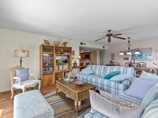 134 Mariner Dr Unit 134, Tarpon Springs, FL 34689 - living room featuring a textured ceiling, light hardwood / wood-style floors, and ceiling fan
