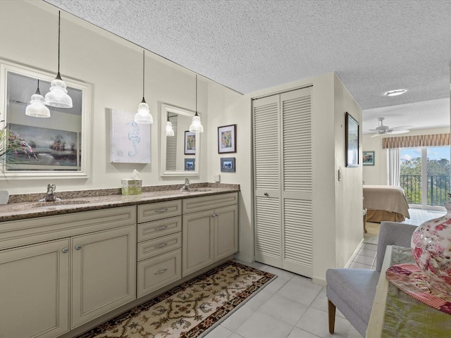134 Mariner Dr Unit 134, Tarpon Springs, FL 34689 - bathroom with vanity, ceiling fan, tile patterned floors, and a textured ceiling