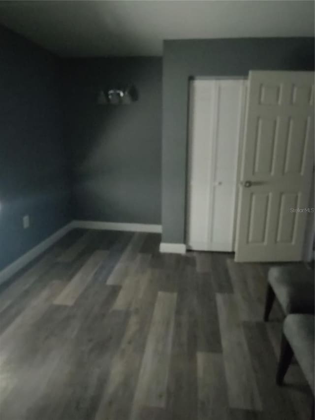 spare room with dark hardwood / wood-style floors