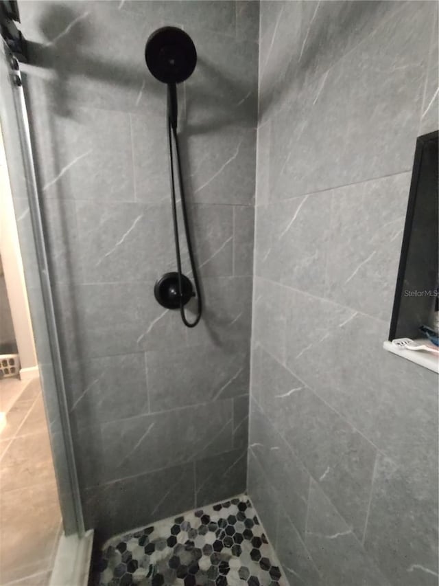 bathroom with tiled shower