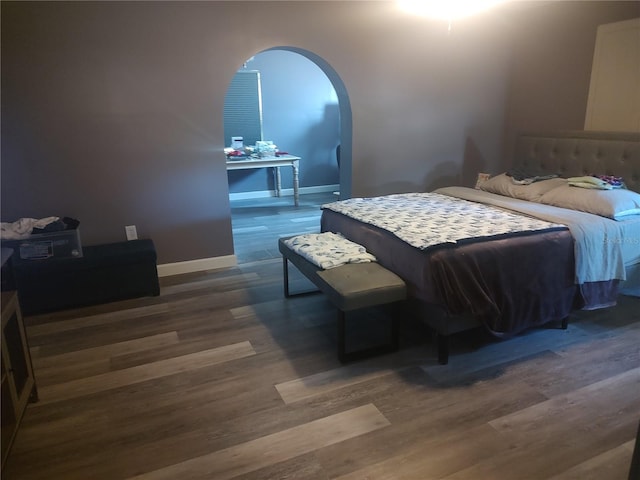 bedroom with dark wood-type flooring