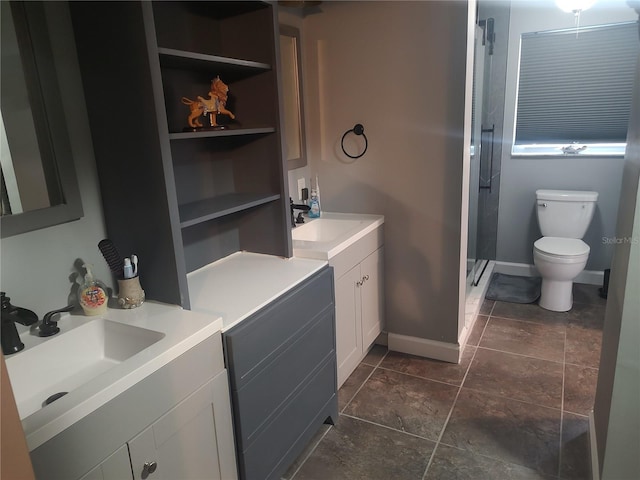 bathroom with vanity, tile patterned floors, toilet, and walk in shower