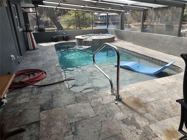 view of swimming pool with an in ground hot tub, glass enclosure, and a patio area