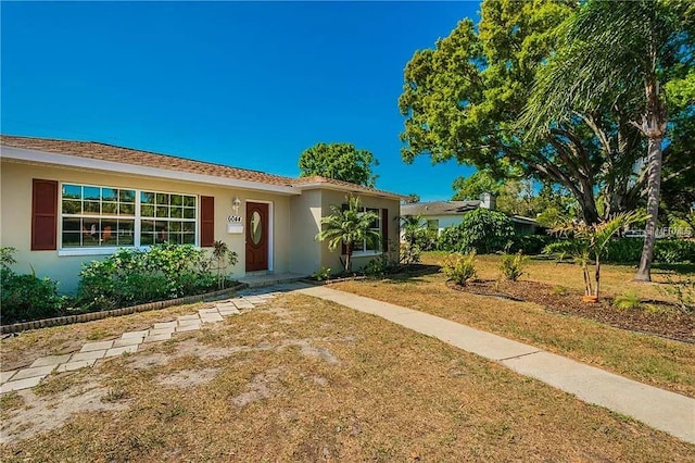 ranch-style house with a front lawn