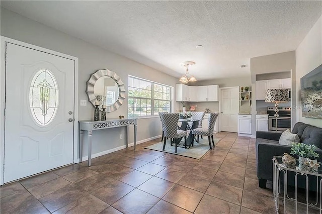 tiled dining space with a textured ceiling