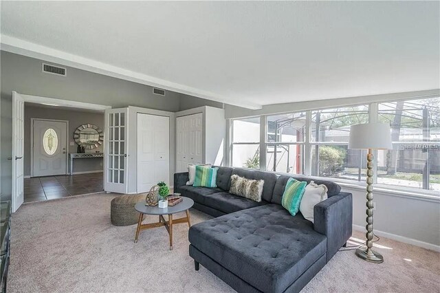 living room featuring french doors and carpet