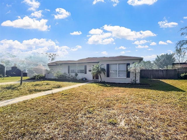 ranch-style home with a front lawn