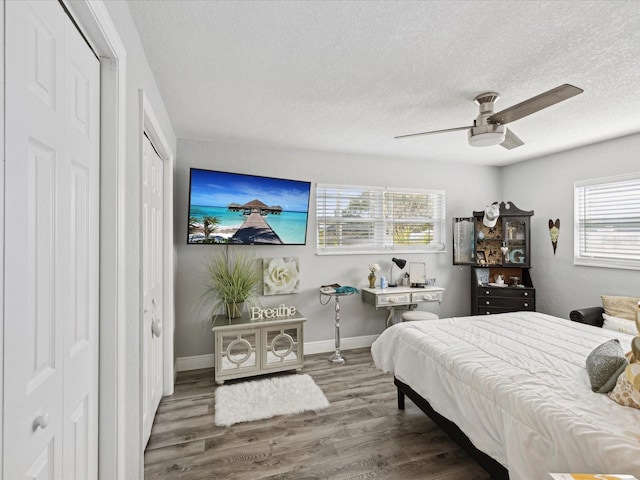 bedroom featuring wood-type flooring, ceiling fan, and a textured ceiling