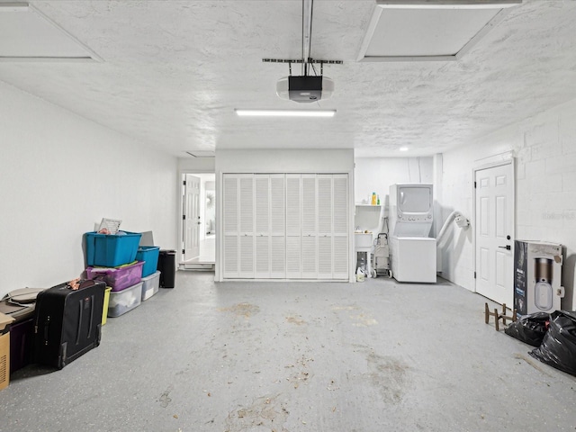 garage featuring a garage door opener and stacked washing maching and dryer