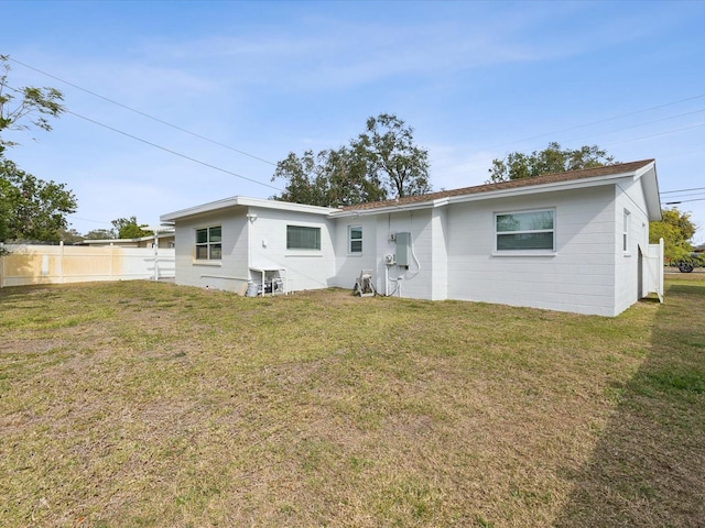 back of house with a lawn