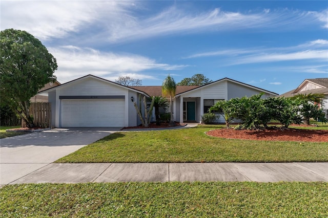 ranch-style home with a garage and a front lawn