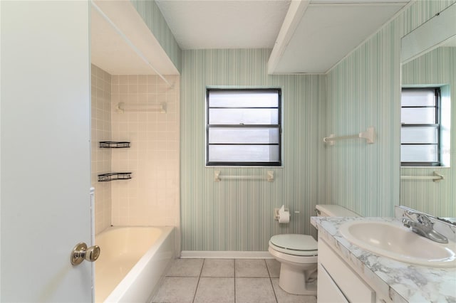 full bathroom featuring tiled shower / bath, vanity, toilet, and tile patterned flooring