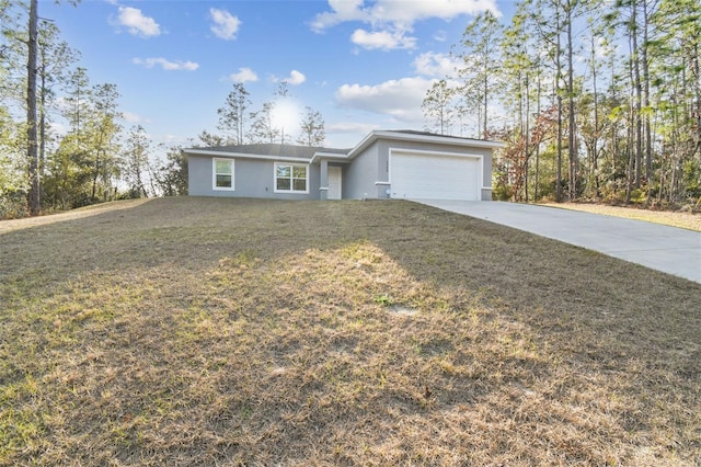 ranch-style home featuring a garage and a front lawn