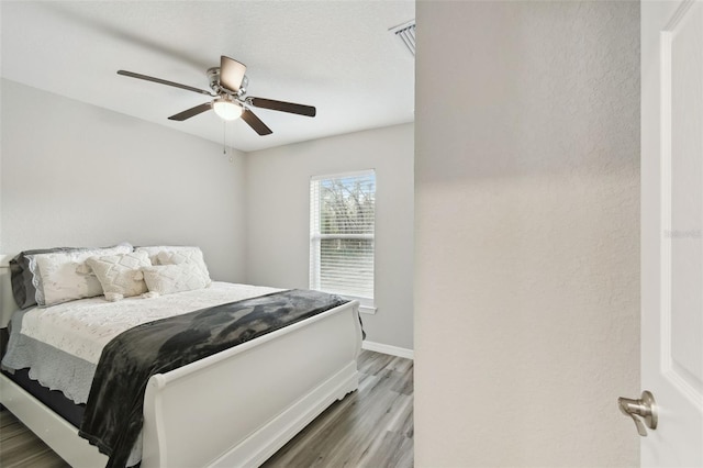 bedroom with hardwood / wood-style floors and ceiling fan