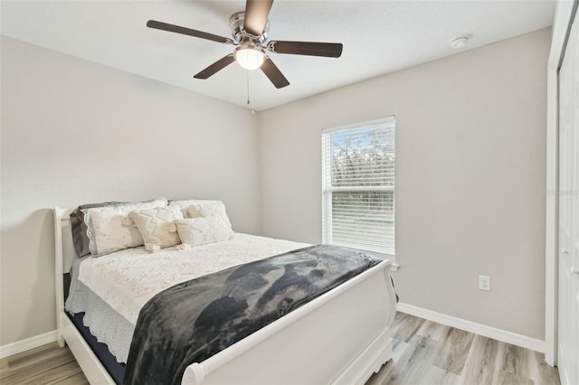 bedroom featuring light hardwood / wood-style flooring and ceiling fan