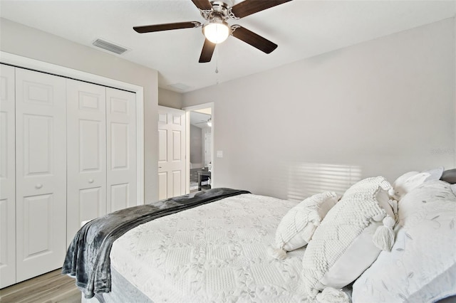 bedroom with ceiling fan, a closet, and light wood-type flooring