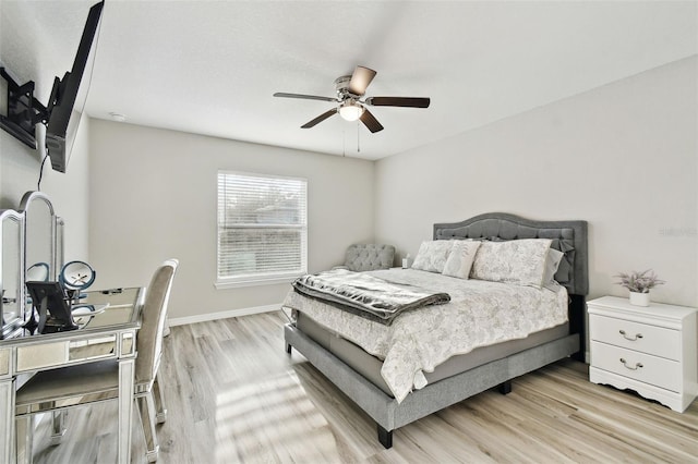 bedroom with ceiling fan and light hardwood / wood-style flooring