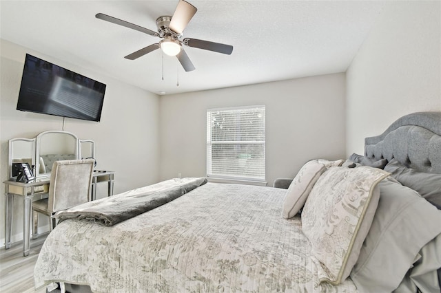 bedroom with light hardwood / wood-style floors and ceiling fan