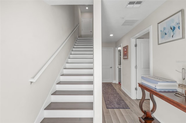 stairs featuring wood-type flooring