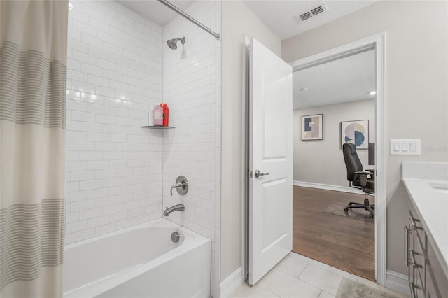 bathroom with shower / bath combination with curtain, vanity, and tile patterned flooring