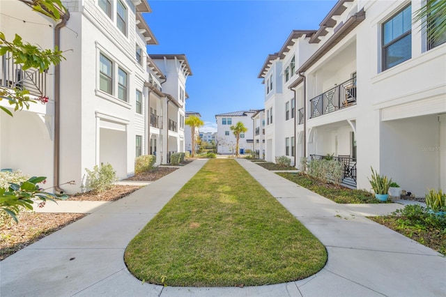 view of property's community featuring a yard