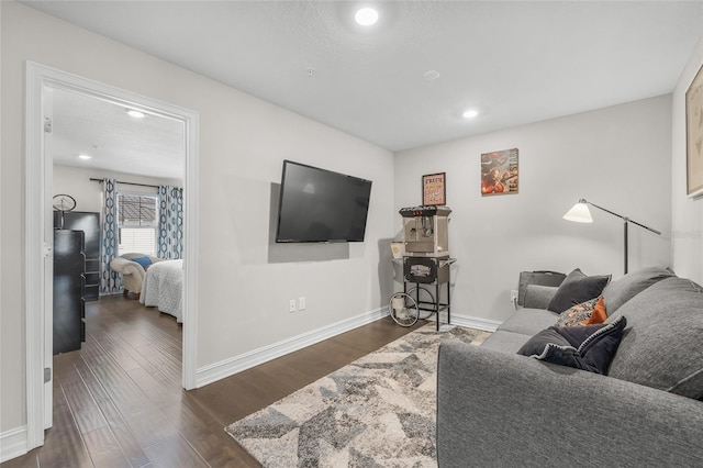 living room with dark hardwood / wood-style floors and a textured ceiling