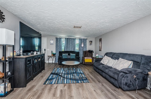 living room featuring hardwood / wood-style flooring and a textured ceiling