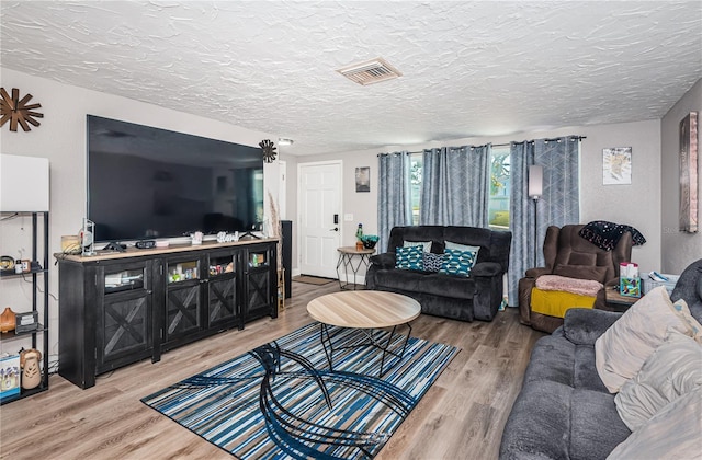 living room featuring hardwood / wood-style floors and a textured ceiling