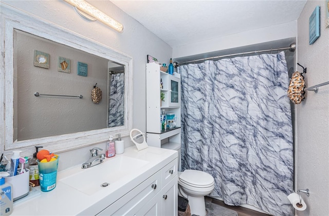 bathroom with walk in shower, vanity, toilet, and hardwood / wood-style flooring