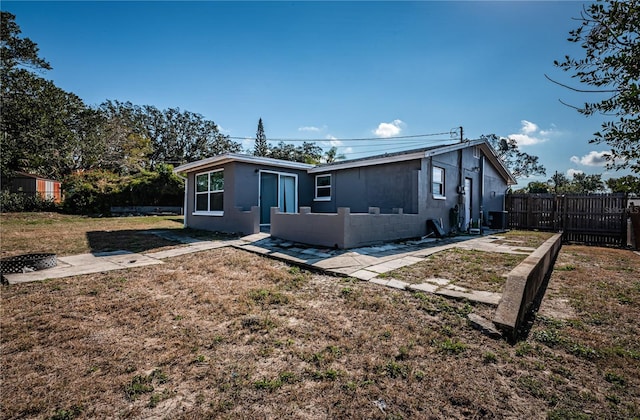 back of house with a yard and central air condition unit