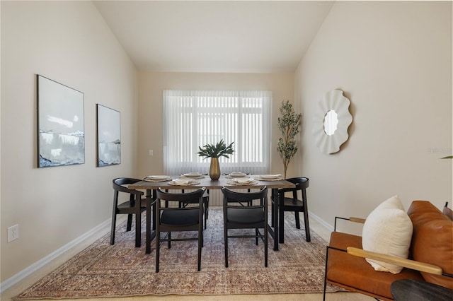 dining space featuring lofted ceiling