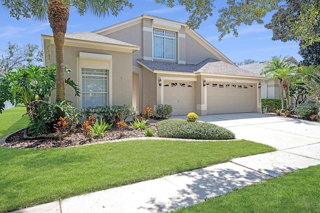 view of front of property with a shingled roof, concrete driveway, a front yard, stucco siding, and an attached garage