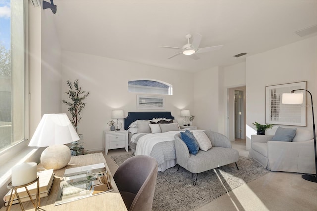 carpeted bedroom with multiple windows and ceiling fan