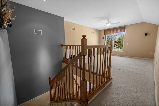 hallway featuring lofted ceiling and carpet