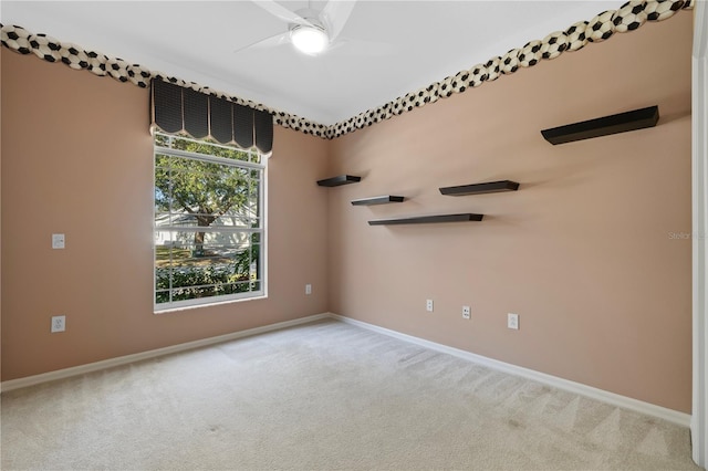 unfurnished room featuring light carpet and ceiling fan