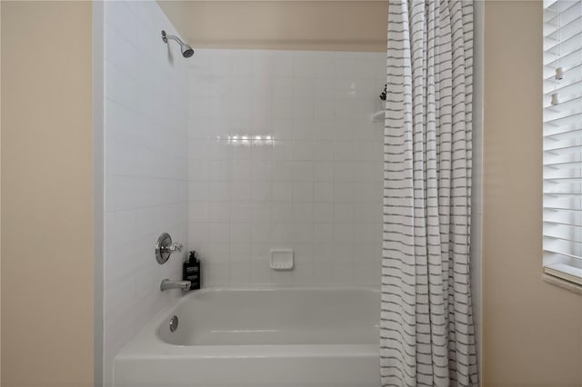 bathroom with shower / bath combo with shower curtain