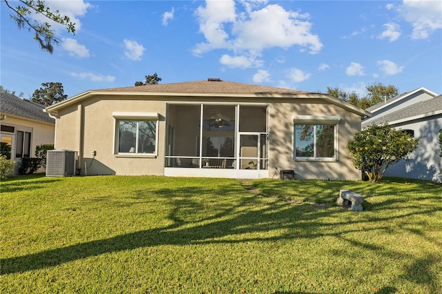 back of property featuring central AC, a lawn, and a sunroom