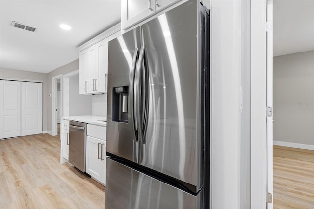 kitchen featuring white cabinetry, stainless steel fridge with ice dispenser, and light hardwood / wood-style floors