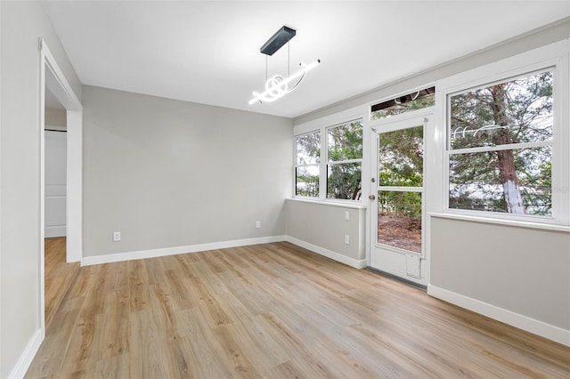 interior space featuring a notable chandelier and light hardwood / wood-style flooring