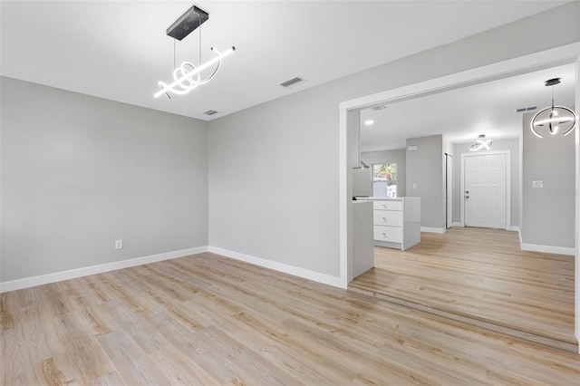 spare room featuring light wood-type flooring