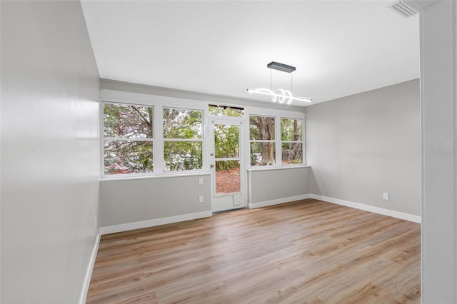 spare room with light hardwood / wood-style floors